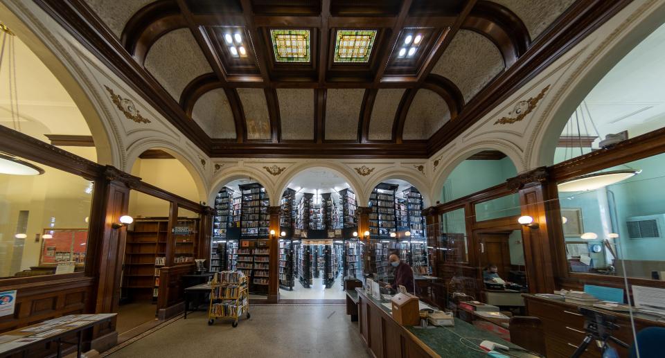 The New Brunswick Free Public Library has original metal shelves, a coffered ceiling, stained glass skylights and many decorative surfaces, including classic details like Doric piers.