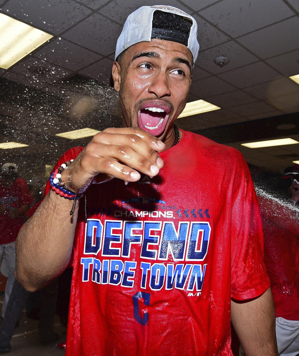 Cleveland Indians Francisco Lindor celebrates in the clubhouse after the Indians defeated the Detroit Tigers 15-0 to clinch the American League Central Division, in a baseball game, Saturday, Sept.15, 2018, in Cleveland. (AP Photo/David Dermer)