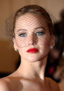 Celebrities wearing red lipstick: Jennifer Lawrence teamed her pout with a netted headpiece. <br><br>[Rex]