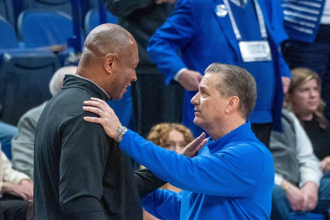 Louisville head coach Kenny Payne, left, and Kentucky head coach John Calipari talk after the Wildcats defeated the Cardinals in last season’s game.