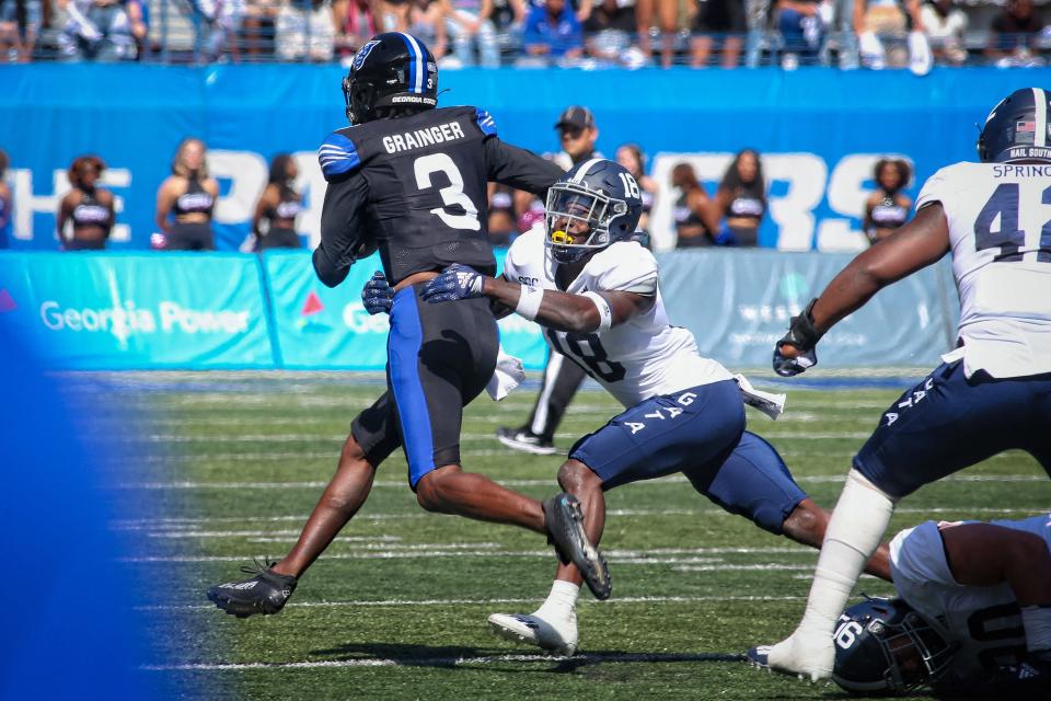 Georgia Southern's Justin Birdsong (18) makes a tackle on Georgia State quarterback Darren Grainger (3) on Saturday in Atlanta. 