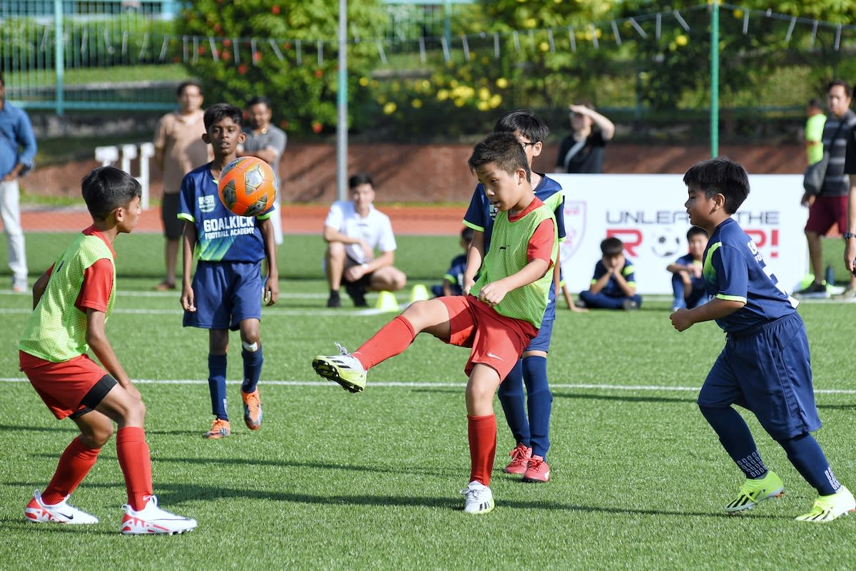 Young footballs from Liverpool FC IA Singapore U12 (red jerseys) taking on GoalKick Football Academy U12 on the opening weekend of the inaugural Singapore Youth League. (PHOTO: SYL)