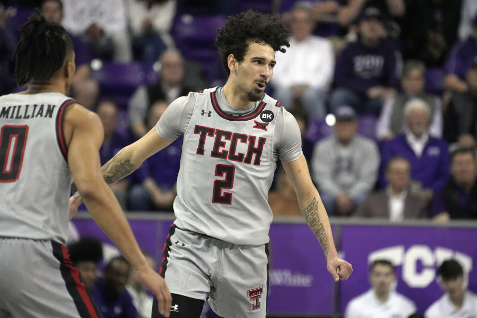 Texas Tech guard Pop Isaacs (2) celebrates after sinking a three-point basket as Chance McMillian (0) looks on in the first half of an NCAA college basketball game against TCU in Fort Worth, Texas, Tuesday, Jan. 30, 2024. (AP Photo/Tony Gutierrez)