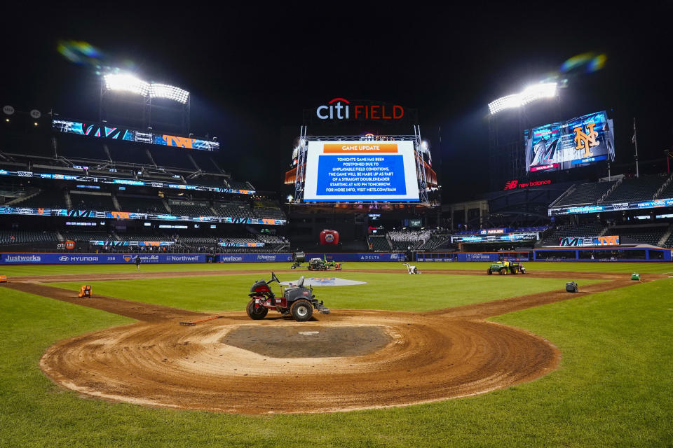 Ground crews work on the field at Citi Field after the baseball game between the New York Mets and the Miami Marlins was postponed due to unplayable field conditions Tuesday, Sept. 26, 2023, in New York. (AP Photo/Frank Franklin II)