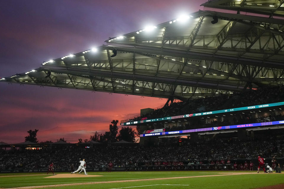 New York Yankees' pitcher Luis Serna, right, throws against Diablos Rojos' Jose Briceno at the second inning during an exhibition baseball game at Alfredo Harp Helu Stadium in Mexico City, Monday, March 25, 2024. (AP Photo/Fernando Llano)