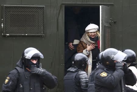 A woman, who was detained by law enforcement officers, reacts during a gathering, denouncing the new tax on those not in full-time employment and marking the 99th anniversary of the proclamation of the Belarussian People's Republic, in Minsk, Belarus, March 25, 2017. REUTERS/Vasily Fedosenko