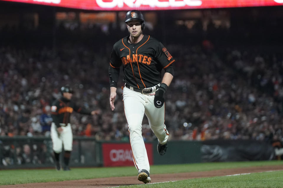 San Francisco Giants' Austin Slater runs home to score against the Los Angeles Dodgers during the sixth inning of a baseball game in San Francisco, Saturday, Sept. 30, 2023. (AP Photo/Jeff Chiu)