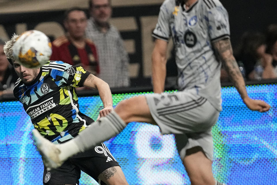 Atlanta United midfielder Saba Lobjanidze (9) takes a shot on goal against CF Montréal defender Gabriele Corbo (25) during the first half of a MLS soccer match, Saturday, Sept. 23, 2023, in Atlanta. (AP Photo/Mike Stewart)