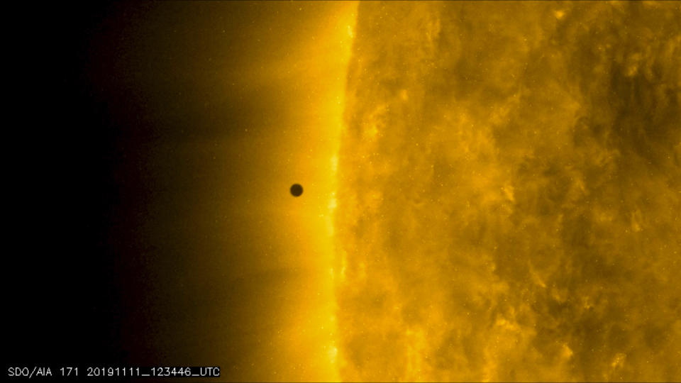 This still image from video issued by NASA's Solar Dynamics Observatory shows Mercury as it passes between Earth and the sun on Monday, Nov. 11, 2019. The solar system's smallest, innermost planet resembles a tiny black dot during the transit, which began at 7:35 a.m. EST (1205 UTC). (NASA Solar Dynamics Observatory via AP)