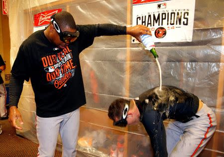 Oct 5, 2014; Detroit, MI, USA; Baltimore Orioles center fielder Adam Jones (10) celebrates in the locker room after defeating the Detroit Tigers in game three of the 2014 ALDS baseball playoff game at Comerica Park. The Orioles move on to the ALCS with 2-1 win over the Tigers. Mandatory Credit: Rick Osentoski-USA TODAY Sports