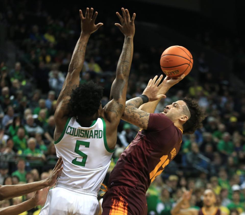 Arizona State's Jose Perez, right, is fouled by Oregon's Jermaine Couisnard during the first half at Matthew Knight Arena Thursday, Jan. 25, 2024.