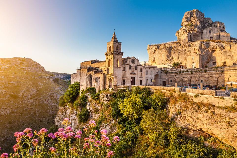 <p>The Post Office highlights the ancient city of Matera as a travel hotspot for this year. The historic cave city in the Basilicata region is this year's European Capital of Culture and is cheaper than other nearby Italian tourist destinations.</p><p><a class="link " href="https://www.airbnb.co.uk/wishlists/420537754" rel="nofollow noopener" target="_blank" data-ylk="slk:Find Airbnbs in Matera;elm:context_link;itc:0;sec:content-canvas">Find Airbnbs in Matera</a></p>