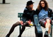 <p>Black leather jacket, minidress, black tights, and booties — not only has Bridget Fonda’s outfit somehow not aged at all — it basically just looks like the L train on any given Tuesday. Wish we could say the same for Matt Dillon’s very Pearl Jam man-shorts lewk. (Photo: Everett Collection) </p>