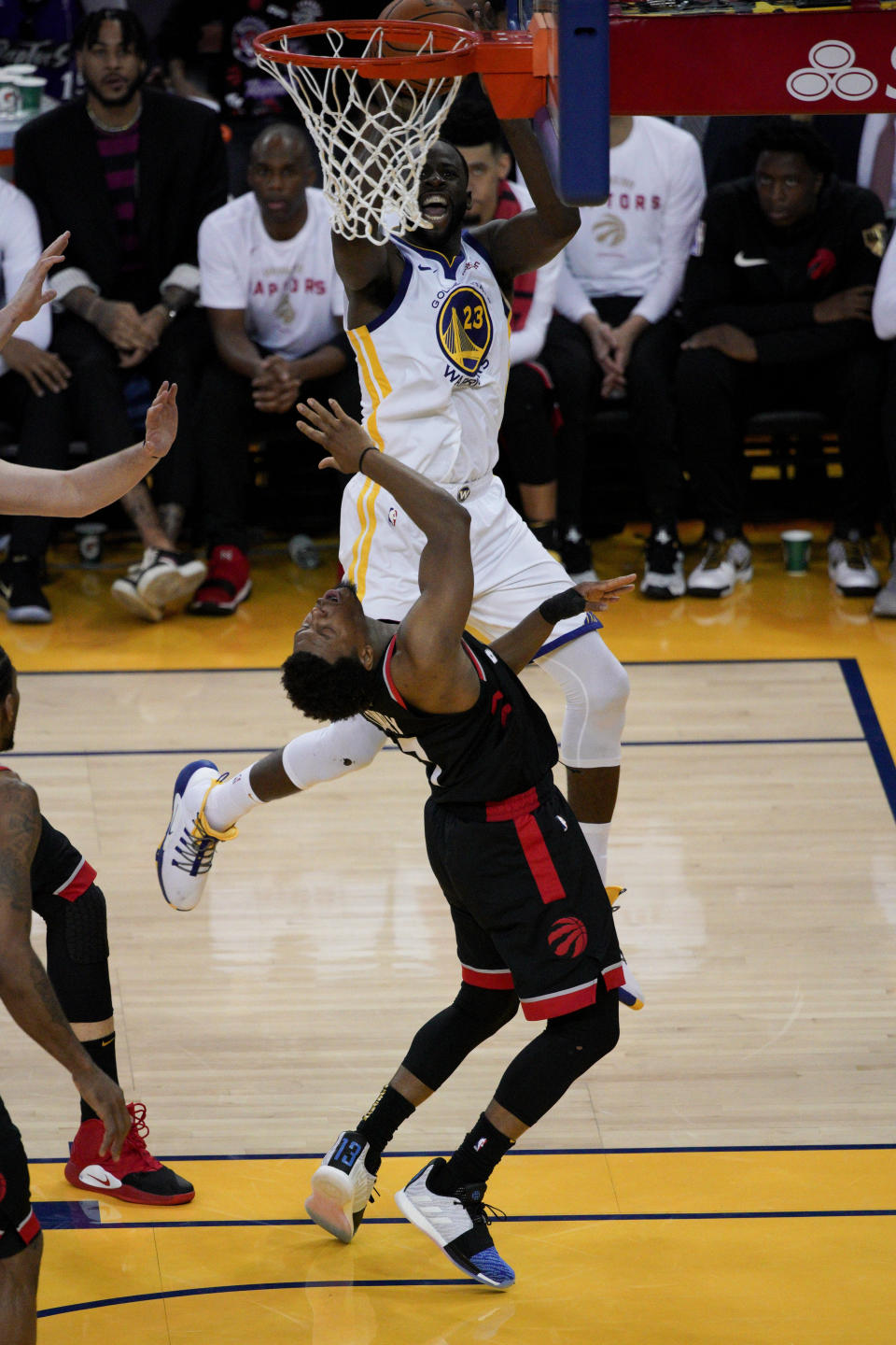 Golden State Warriors forward Draymond Green (23) shoots over Toronto Raptors guard Kyle Lowry during the first half of Game 3 of basketball's NBA Finals in Oakland, Calif., Wednesday, June 5, 2019. (AP Photo/Tony Avelar)