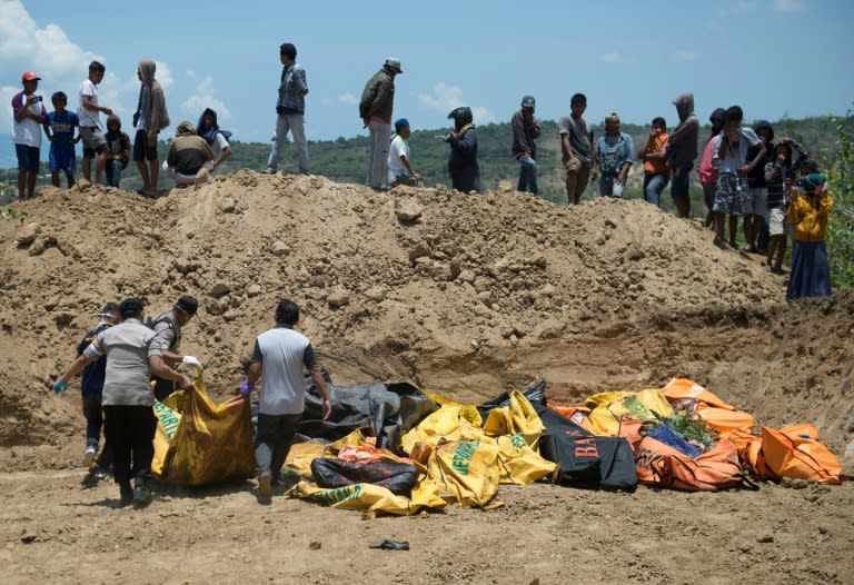 Volunteers have dug a mass grave for victims of the quake in Palu city