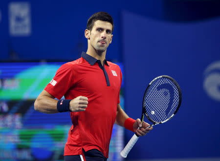 Novak Djokovic of Serbia reacts after wining a point against John Isner of U.S. during their men's singles match at the China Open tennis tournament in Beijing, China, October 9, 2015. REUTERS/Kim Kyung-Hoon