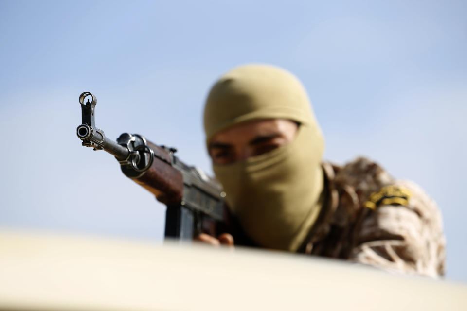 A soldier loyal to Abdul Hamid Dbeibah, one of Libya’s two rival prime ministers, patrols a street of the capital, Tripoli, Tuesday May, 17, 2022. Clashes broke out in Tripoli after Dbeibah’s rival, Prime Minister Fathi Bashagha, announced his arrival in the city on Tuesday morning. But Bashagha left soon after the fighting started. (AP Photo/Yousef Murad)