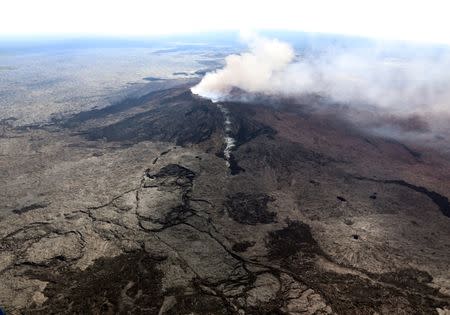 The Kilauea Volcano fissure that formed on the west flank of the Pu'u 'O'o cone (line of white steam) is seen in this aerial image after the volcano erupted following a series of earthquakes over the last couple of days, in Hawaii, U.S. on May 3, 2018. Picture taken on May 3, 2018. USGS/Handout via REUTERS