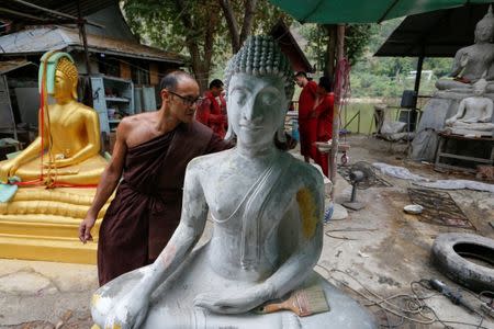 Jeremy, a Buddhist monk from Australia, inspects a Buddha statue at a workshop at the rehabilitation and detox area at Wat Thamkrabok monastery in Saraburi province, Thailand, February 3, 2017. REUTERS/Jorge Silva