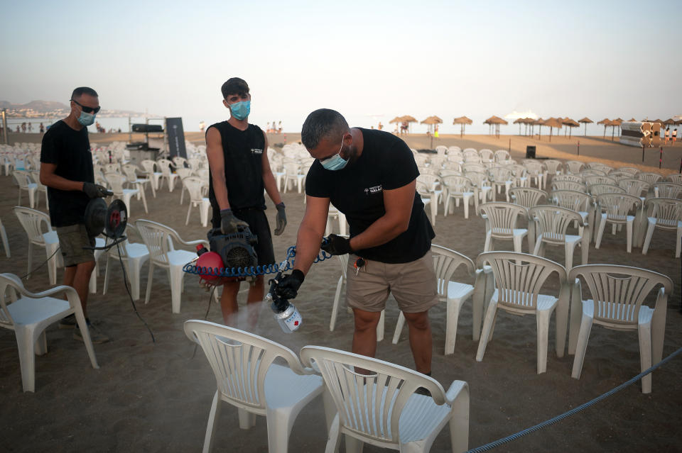  Workers are seen disinfecting chairs before the movie at La Malagueta beach amid coronavirus (COVID-19) outbreaks. During the summer season, the event 'Open cinema' welcomes free screenings of movies from 2 July until 20 August in different outdoors places like beaches, parks or district zones as people enjoy free films on this occasions, this places have to adapt safety and health measures to prevent the spread of coronavirus pandemic. (Photo by Jesus Merida / SOPA Images/Sipa USA) 