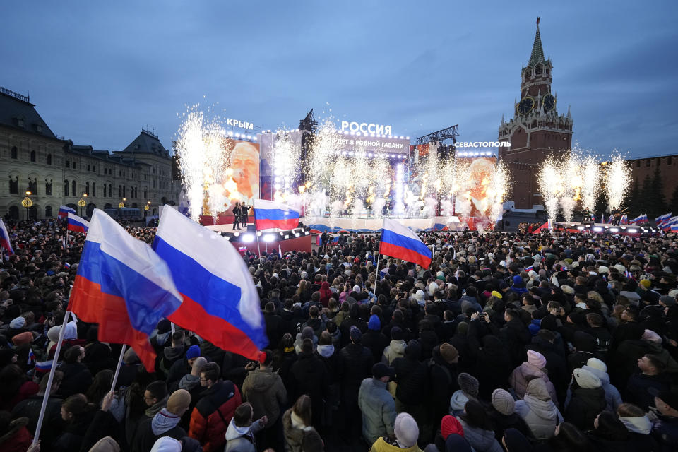 People watch a concert marking the 10-year anniversary of Crimea's annexation by Russia on Red Square in Moscow, Russia, Monday, March 18, 2024. President Vladimir Putin seized Crimea from Ukraine a decade ago, a move that sent his popularity soaring but was widely denounced as illegal. (AP Photo/Alexander Zemlianichenko)