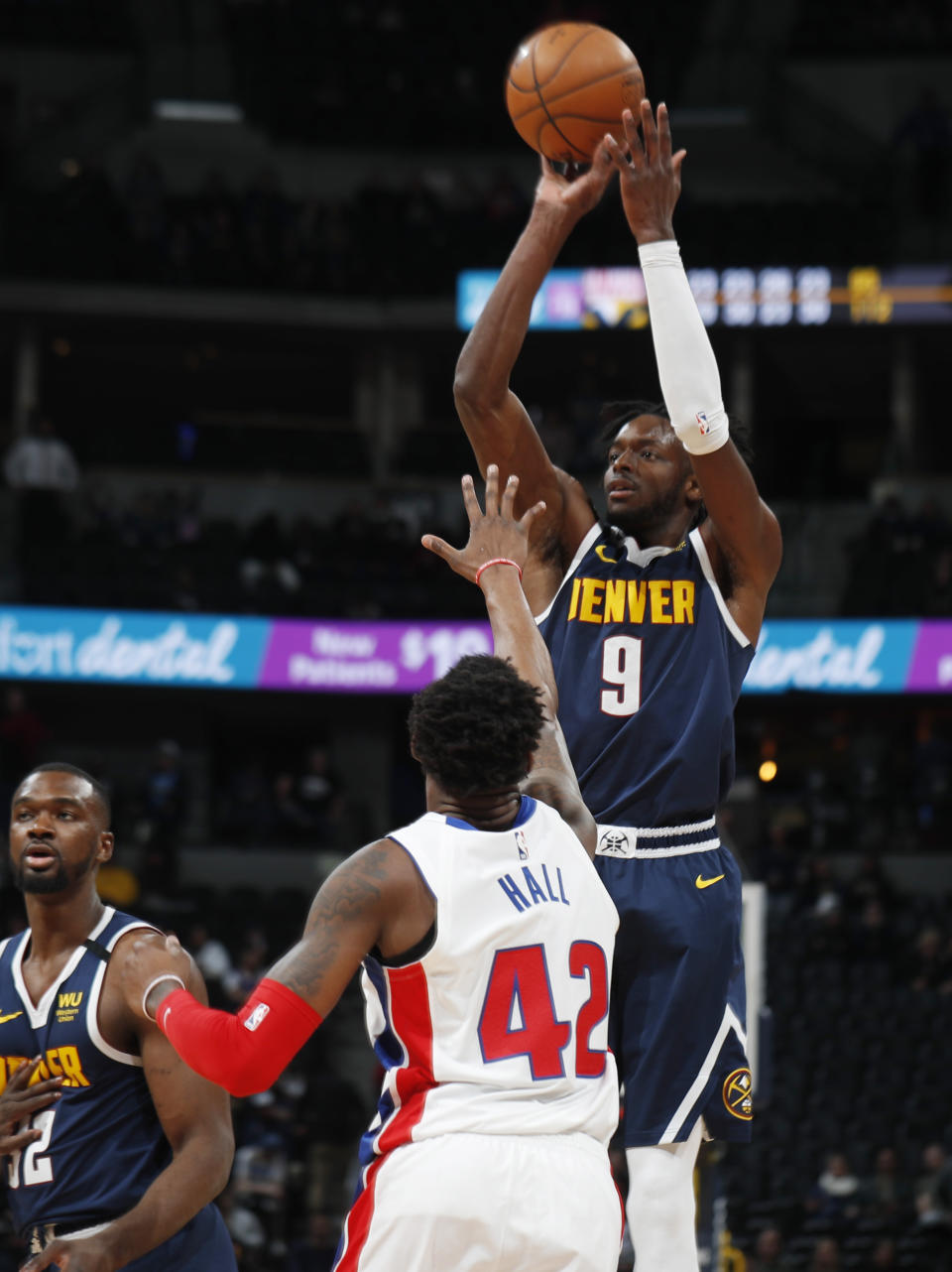Denver Nuggets forward Jerami Grant, back, shoots over Detroit Pistons center Donta Hall late in the second half of an NBA basketball game Tuesday, Feb. 25, 2020, in Denver. The Nuggets won 115-98. (AP Photo/David Zalubowski)