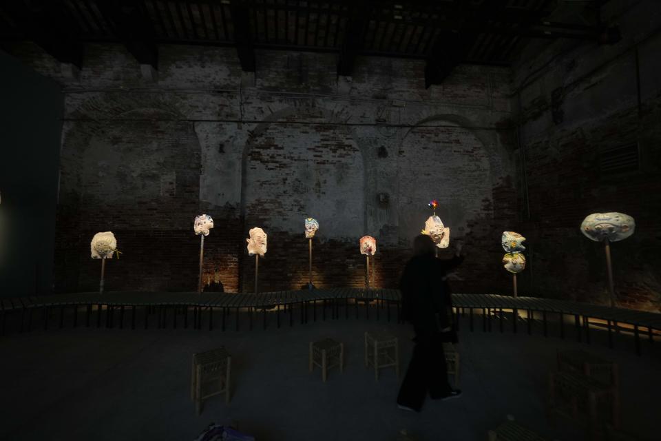 Visitors look the installation "A Dance With Her Myth," by artist Mounira Al Solh at the Lebanese pavilion of the 60th Biennale of Arts exhibition in Venice, Italy, Tuesday, April 16, 2024. The Venice Biennale contemporary art exhibition opens Saturday for its six-month run through Nov. 26. (AP Photo/Luca Bruno)