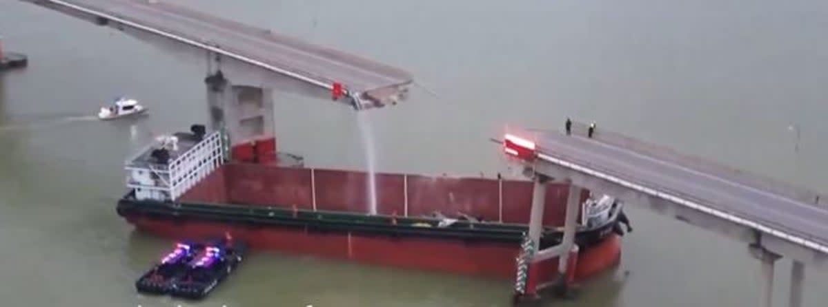 The cargo vessel was lodged diagonally between two pillars of the bridge (Screengrab/ CCTV)
