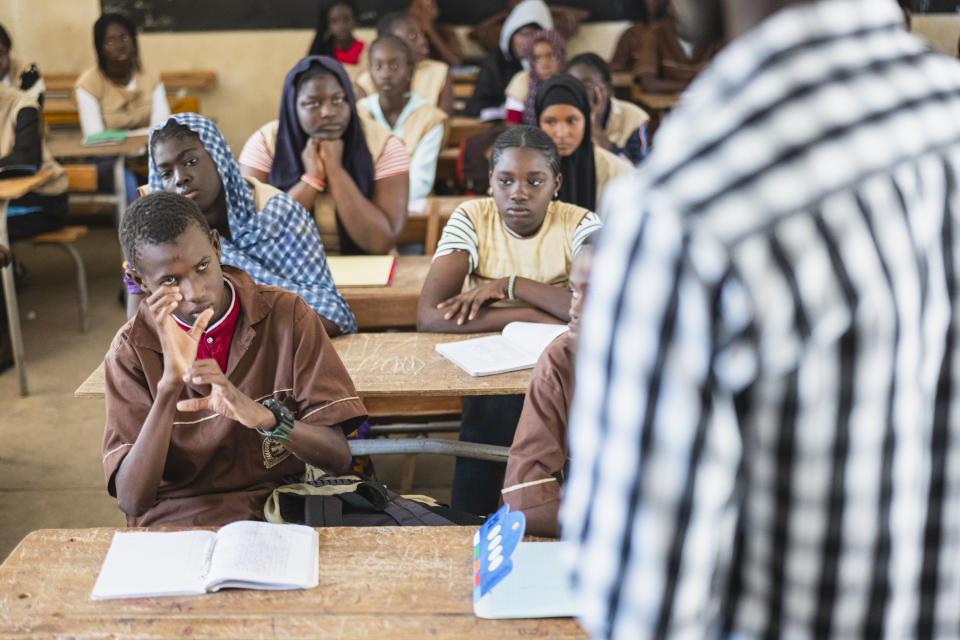 Mouhamed Sall, who is deaf, communicates using sign language at the Guinaw Rail Sud public high school in Pikine, Senegal, Monday, March 18, 2024. Sall and three other students are part of a new approach in a small number of schools in Senegal that seat those who are deaf and hard of hearing with the rest of the class. (AP Photo/Sylvain Cherkaoui)