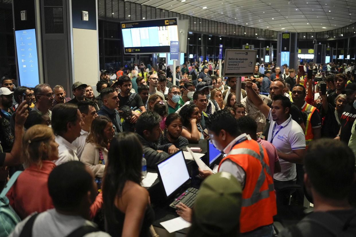 Passengers try to reschedule their flights after many were canceled or delayed due to Hurricane Ian at Tocumen International Airport in Panama City, Fla. on Tuesday, Sept. 27, 2022. Hurricane Ian tore into western Cuba as a major hurricane and left 1 million people without electricity, then churned on a collision course with Florida over warm Gulf waters amid expectations it would strengthen into a catastrophic Category 4 storm.