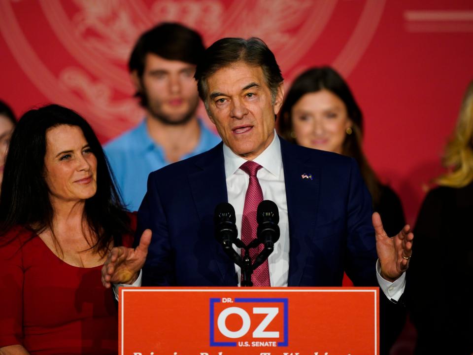Mehmet Oz, the Republican candidate for U.S. Senate in Pennsylvania, speaks to supporters at an election night rally in Newtown, Pa., Tuesday, Nov. 8, 2022, as his wife Lisa listens.