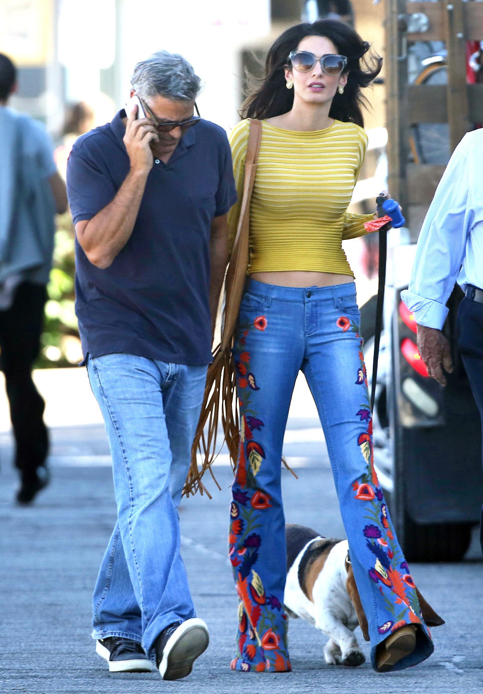 Amal Clooney visited George Clooney on a film set in embroidered wide-legged denims and she totally rocked the look! 