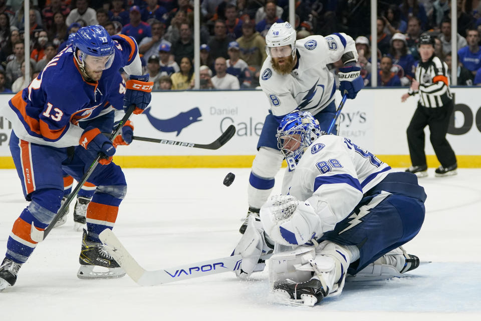 Tampa Bay Lightning goaltender Andrei Vasilevskiy (88) blocks a shot by New York Islanders center Mathew Barzal (13) during the third period of Game 3 of the NHL hockey Stanley Cup semifinals, Thursday, June 17, 2021, in Uniondale, N.Y. Tampa Bay won 2-1.(AP Photo/Frank Franklin II)