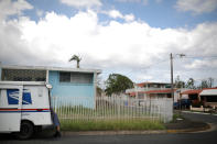 <p>Alfredo Martinez, a mail man for the U.S. Postal Service delivers the mail at an area damaged by Hurricane Maria in San Juan, Puerto Rico, Oct. 6, 2017. (Photo: Carlos Barria/Reuters) </p>