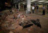 <p>A policeman examines debris that fell and crushed parked motorbikes following a strong earthquake on nearby Lombok island, at a shopping center in Kuta, Bali, Indonesia, Aug. 5, 2018. (Photo: Johannes P. Christo/Reuters) </p>