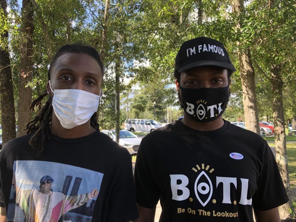 Friends Tre Hall, left, and Justin Lane, right, head to cast their ballots early.