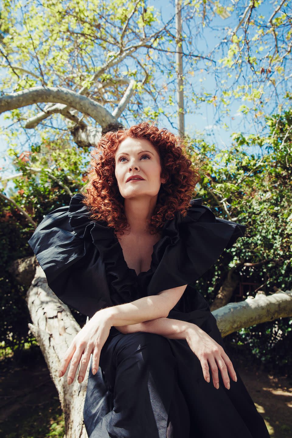 rebecca wisocky posing on tree branch