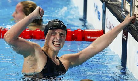 Katie Ledecky of the U.S. celebrates after setting a new world record and winning the women's 800m freestyle final at the Aquatics World Championships in Kazan, Russia, August 8, 2015. REUTERS/Michael Dalder