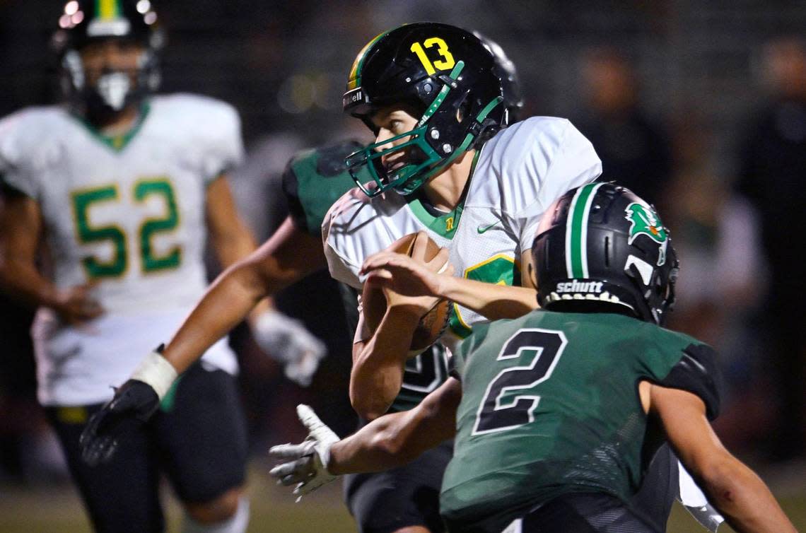 Roosevelt quarterback Jackson Kloster, center, finds an opening in Reedley’s defense on a scramble in the second half Friday night, Aug. 25, 2023 in Reedley. Roosevelt beat Reedley 39-32.