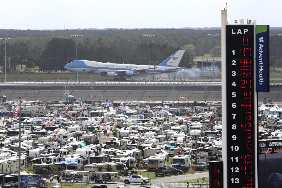 Air Force One touches down at the Daytona Beach International's Airport as seen from Daytona International Speedway as President Donald Trump makes his arrival to attend the NASCAR Daytona 500 auto race, Sunday, Feb. 16, 2020, in Daytona Beach, Fla. (AP Photo/David Graham)