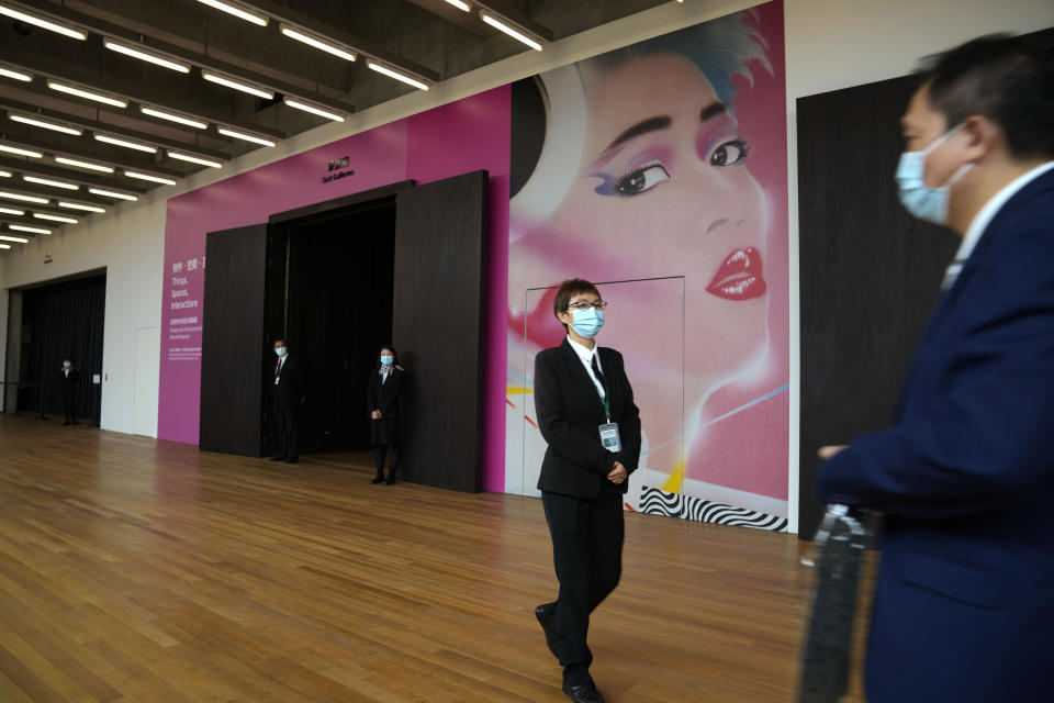 People walk inside the "M+" visual culture museum in the West Kowloon Cultural District of Hong Kong, Thursday, Nov. 11, 2021. Hong Kong's swanky new M+ museum _ Asia's largest gallery with a billion-dollar collection _ is set to open on Friday amid controversy over politics and censorship. (AP Photo/Kin Cheung)