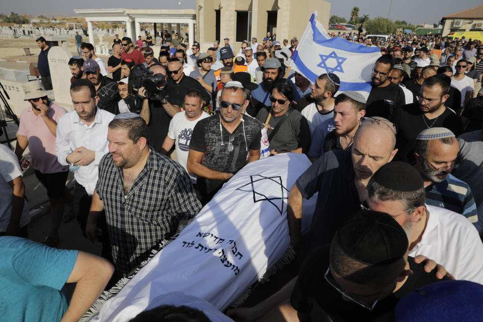 People attend the funeral of 17 year old Rina Shnerb, in Lod, Israel, Friday, Aug. 23, 2019. Shnerb has died of wounds from an explosion in the West Bank that the Israeli military has described as a Palestinian attack. (AP Photo/Sebastian Scheiner)