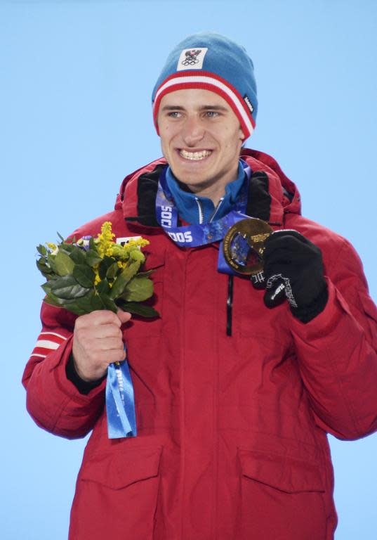 Austria's gold medalist Matthias Mayer poses with his medal on the podium during the Men's Alpine Skiing Downhill Medal Ceremony at the Sochi medals plaza during the Sochi Winter Olympics on February 9, 2014