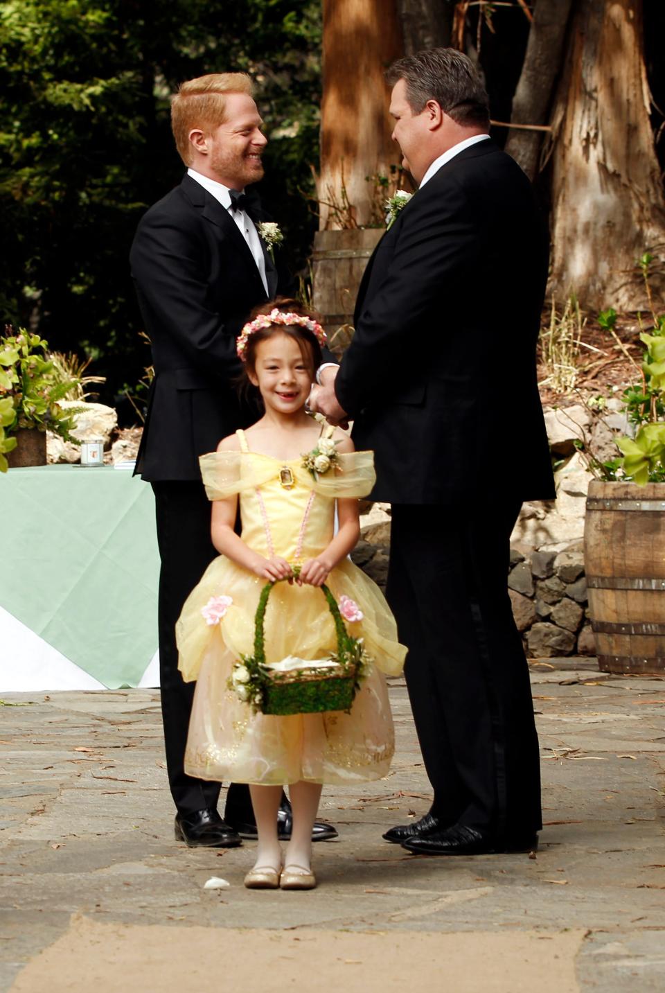 Aubrey Anderson-Emmons, Jesse Tyler Ferguson and Eric Stonestreet in season five of "Modern Family," in which Mitch and Cam got married with their daughter, Lily, serving as flower girl.