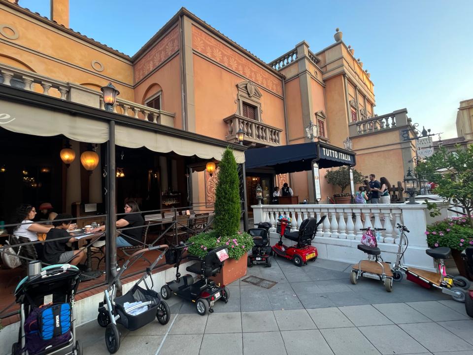 exterior of tutto italia outdoor area on the left, entrance with black awning on the right
