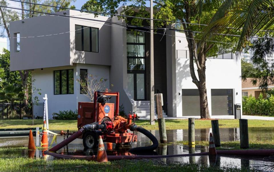 A temporary stormwater pump works to clear a flooded street near Little River Pocket Park on Monday, Oct. 30, 2023 in Miami, Fla. Monday was the highest king tide of the year for South Florida, flooding streets, driveways and parks.