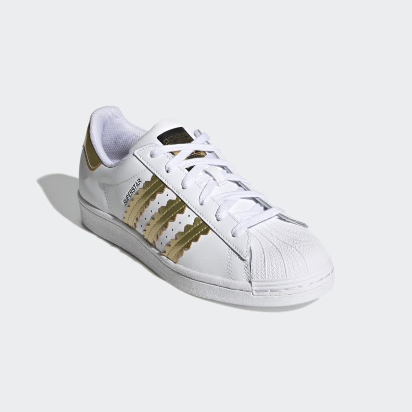 White shoes with gold zig zgs.