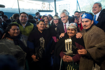 Chile's President Sebastian Pinera poses along with Mapuche indigenous community members during an official ceremony in Temuco, Chile, September 24, 2018. Sebastian Rodriguez/Courtesy of Chilean Presidency/Handout via REUTERS