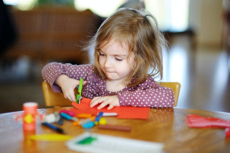 Small girl playing with art supplies at nursery