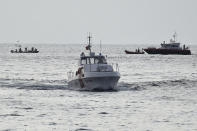 Emergency services at the scene of the search for a missing boat, in Porticello, southern Italy, Tuesday, Aug. 20, 2024. Rescue teams and divers returned to the site of a storm-sunken superyacht Tuesday to search for six people, including British tech magnate Mike Lynch, who are believed to be still trapped in the hull 50 meters (164-feet) underwater. (AP Photo/Salvatore Cavalli)